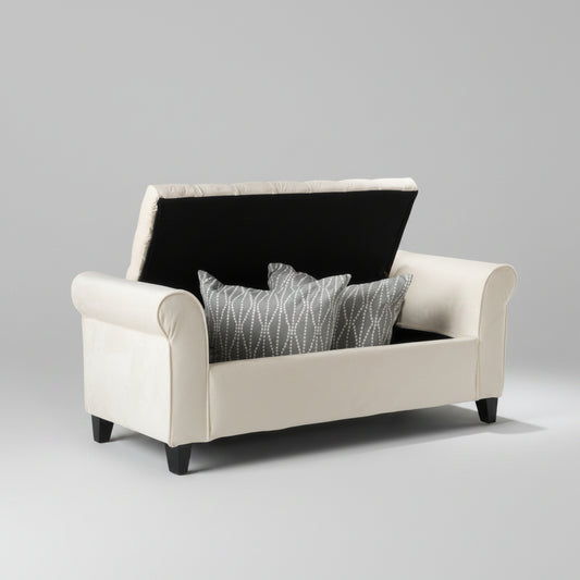 White sofa with black backrest and gray patterned pillow against a gray wall with abstract art.