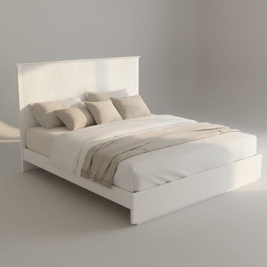 Neatly made bed in a bright bedroom with decor elements.