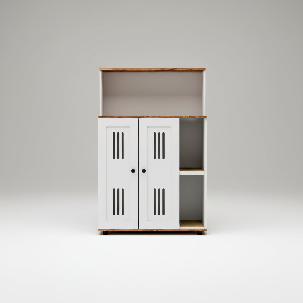 A modern white storage cabinet with two doors, featuring vertical vent slits, black knobs, open side shelves, and a warm wood-look top and shelf trim. The cabinet is styled in a bright, minimalist room next to a white armchair with a textured throw blanket.