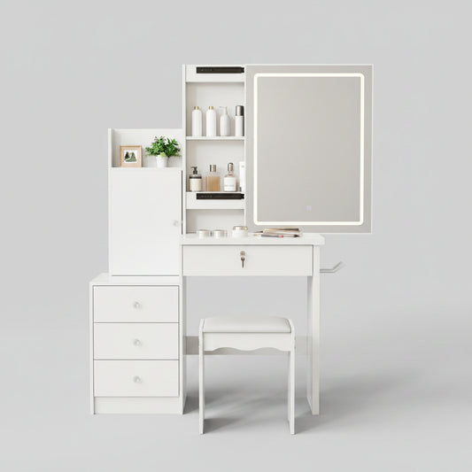 A white vanity desk set with a built-in black-framed mirror, three drawers, open shelving, and a matching white stool, styled in a beige room with decorative accessories.