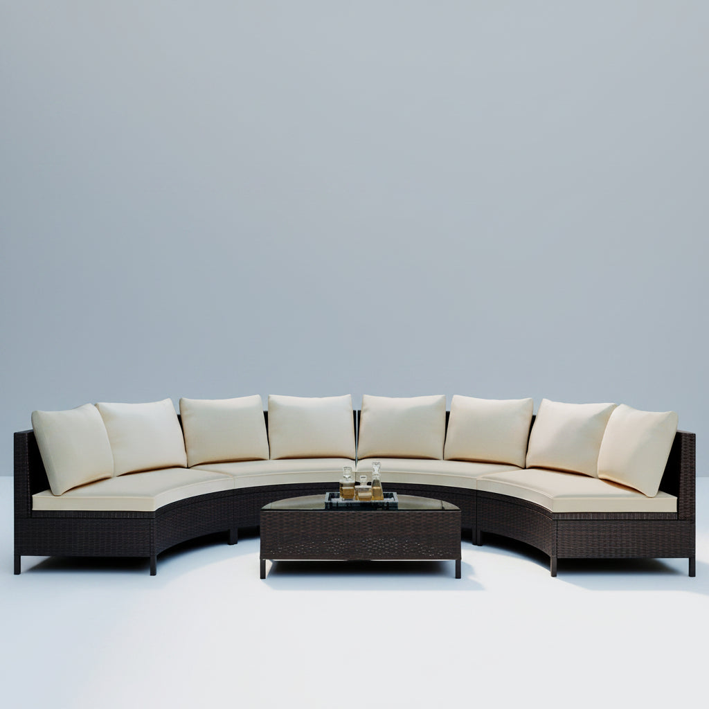 Outdoor patio set with curved sofa and coffee table in a modern garden setting.