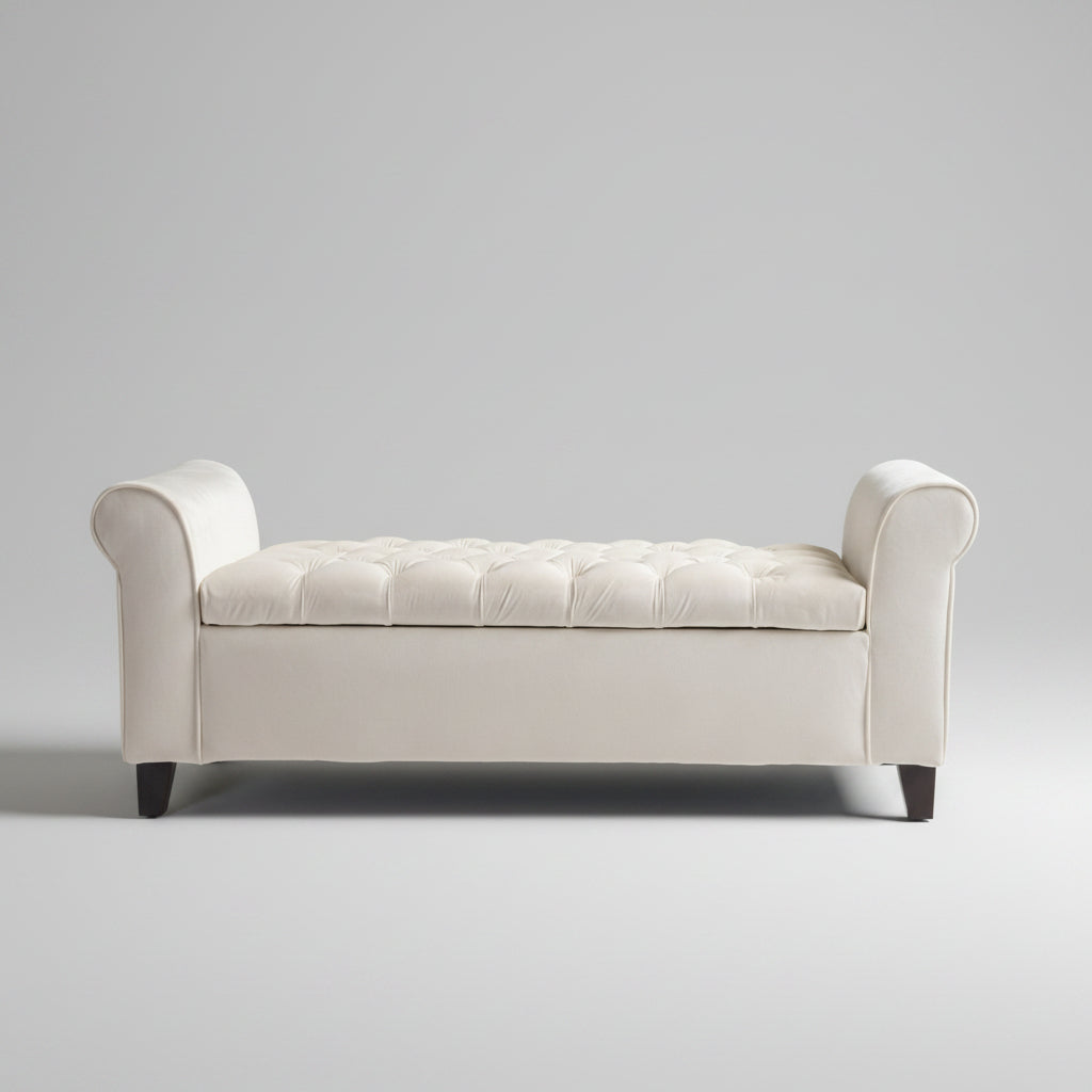White tufted bench in a room with a painting and plant on the wall.